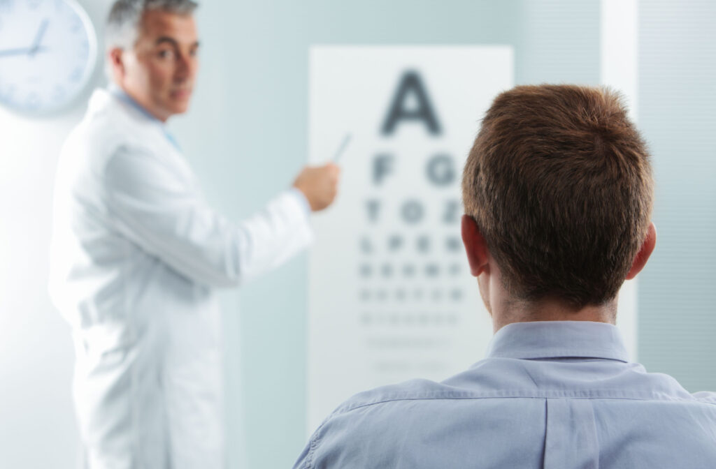 An eye doctor tests a patient's eyesight with an eye chart.