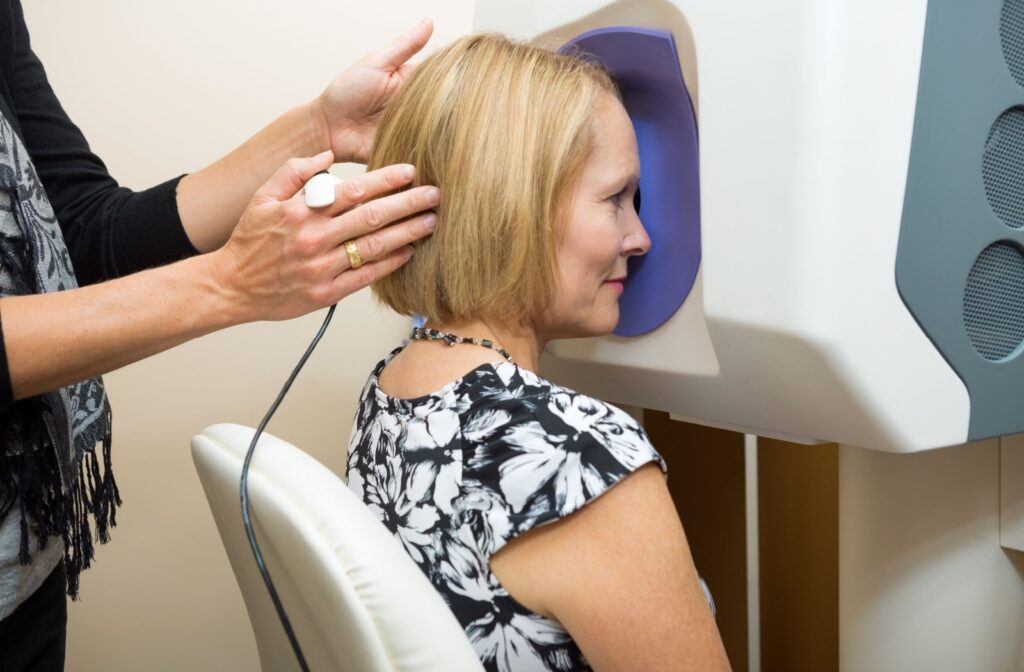 A woman undergoing retinal imaging.