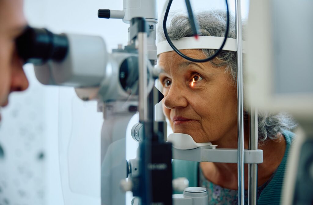 An optometrist assessing a patient's ocular health using a slit lamp.