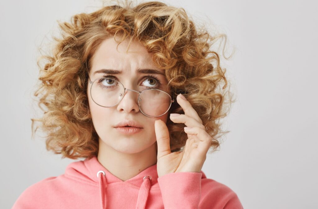 A young, frazzled-looking patient wearing eyeglasses.